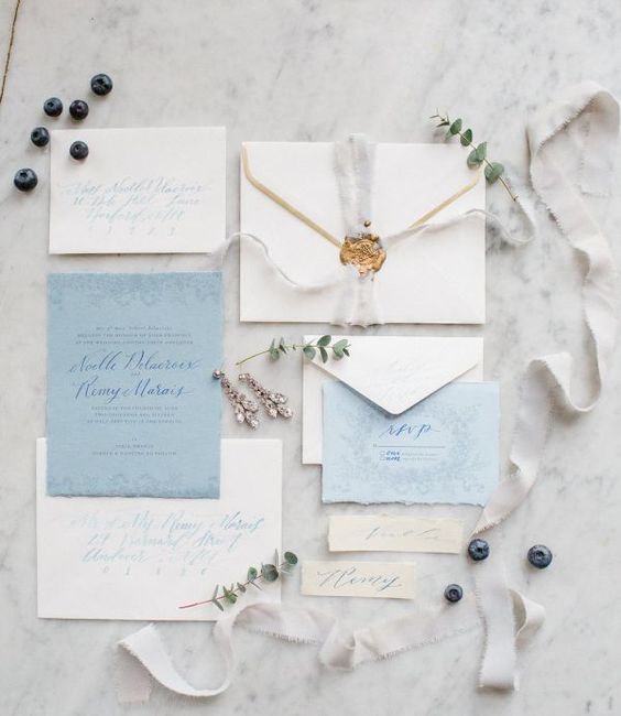neutral and blue wedding stationery with ethereal ribbons, a raw edge and seals