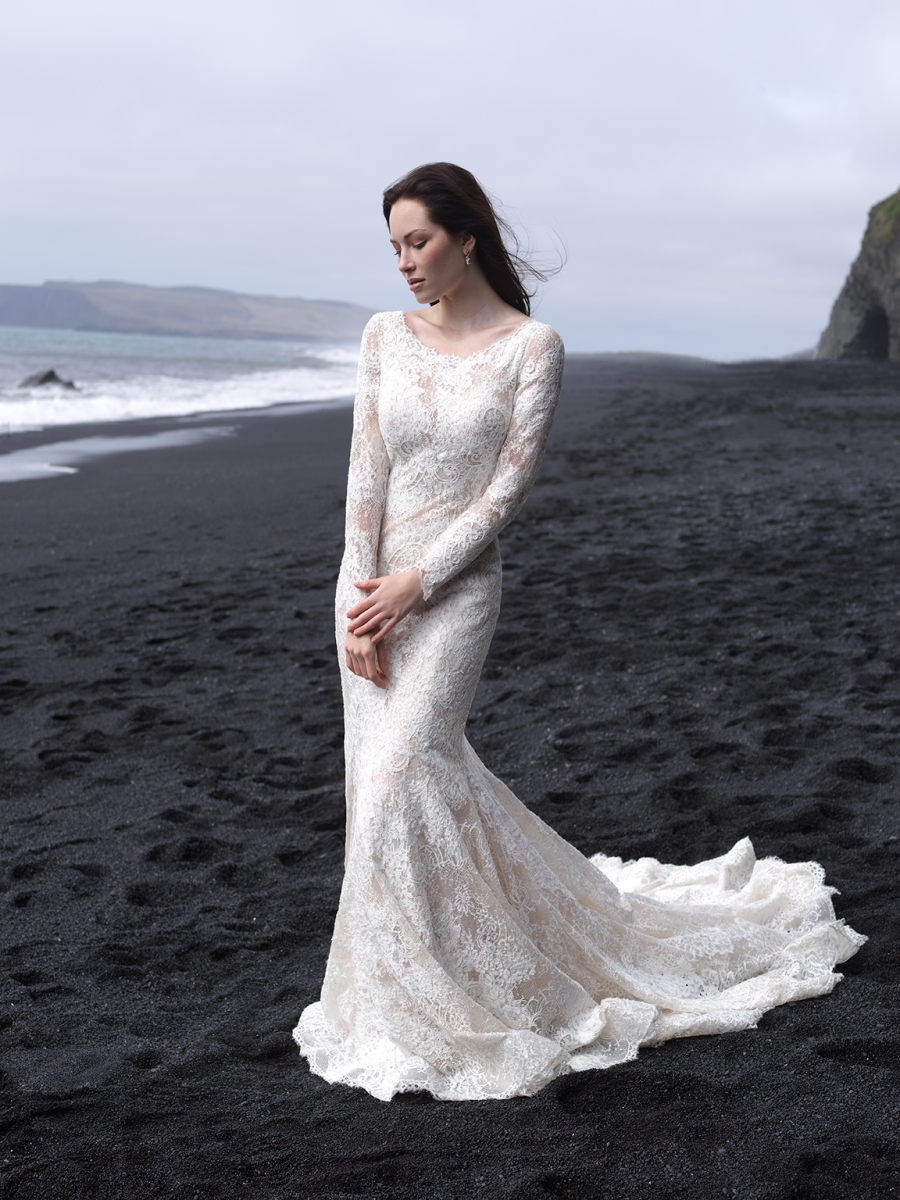 A lace scoop neckline wedding dress with a small train and long sleeves looks very romantic