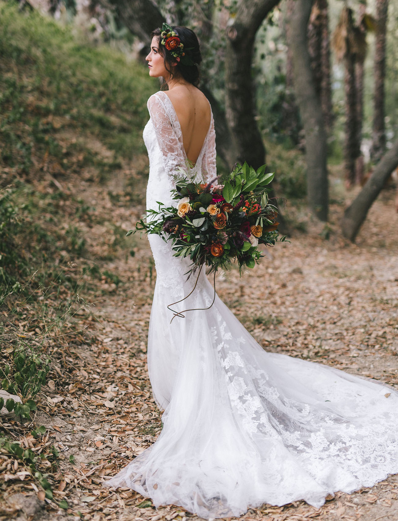 An open back and a train made the dress amazing, and a floral crown matching the bouquet was a moody flal one