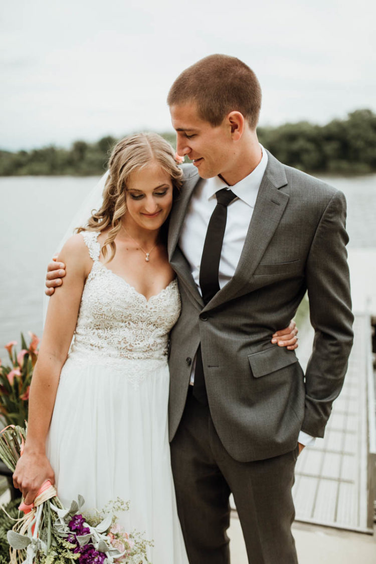 The groom was wearing a grey wedding suit with a black tie