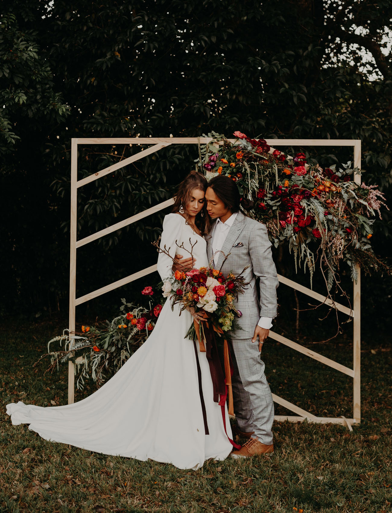 The wedding backdrop was a geometric one, with bold fall florals attached