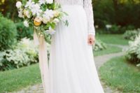 05 a chic wedding gown with a long sleeve lace bodice, a bateau neckline and a flowy skirt