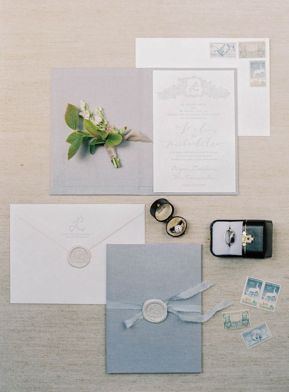 a modern pastel blue invitation set with seals, blue ribbons and pale calligraphy