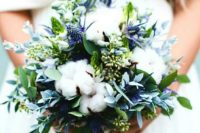 05 a wedding bouquet with cotton, greenery and blue thistles looks textural and very interesting