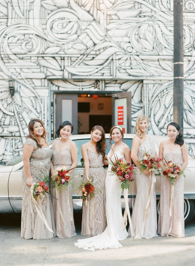 The bridesmaids were wearing mismatching art deco gowns of different neutral shades