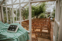 The wedding ceremony took place in an orangery, there’s a lot of greenery and simple folding chairs