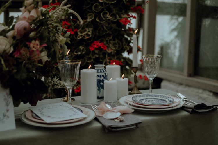 The wedding tablescape was done with blue and pink plates, candles and soft and neutral textiles