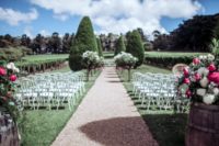 06 This is a gorgeous ceremony space with perfectly manicured trees and bold florals