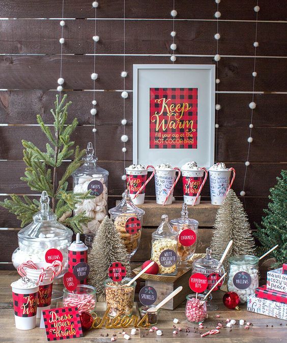 a chic hot chocolate bar with desserts, a sign, a faux Christmas tree and lots of plaid for a Christmas wedding
