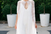 06 a modern spaghetti strap wedding dress with a plunging neckline and a lace cape over the dress
