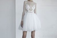 06 a short wedding gown with an illusion bodice and lace appliques on it, long illusion sleeves and a layered skirt