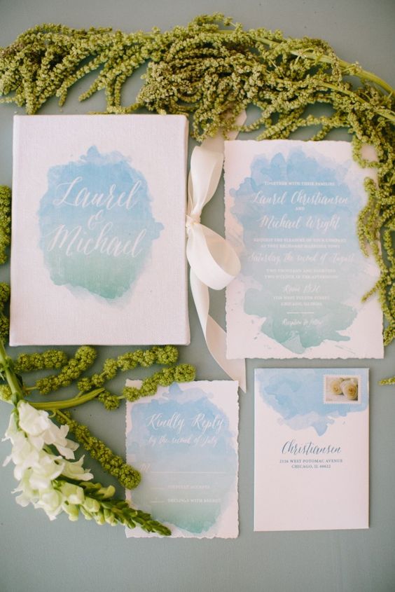 watercolor pastel blue wedding stationery with a raw edge and creamy ribbons