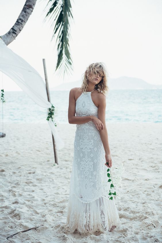 a boho lace wedding dress with a halter neckline and a lace skirt for a beach boho wedding