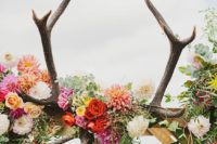 07 a boho wedding atch with bold blooms, foliage and antlers looks cool and bold