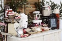 09 a chic hot chocolate bar with fir branches, wood slices, jars with sweets and plaid napkins
