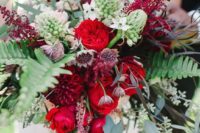 09 a lush bouquet with greenery, red and deep red blooms looks very textural