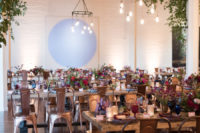 10 The wedding reception was done with vintage wooden tables, metal chairs, industrial chandeliers and greenery