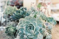 10 a lush succulent wedding centerpiece with candles for a modern wedding