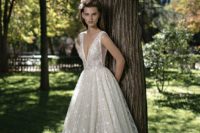 10 a sparkling plunging neckline wedding dress with wide straps and a plunging neckline to make a statement
