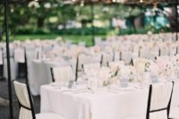 10 an all-white wedding looks amazing with ivory fabric on the chairs to achieve a gorgeous clean look