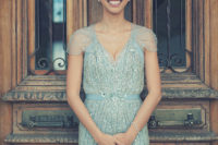 10 ice blue sparkling wedding dress with heavy embellishments, a V-neckline and cap sleeves