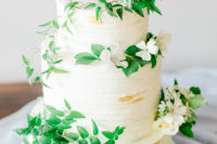 11 The wedding cake was a white one topped with fresh greenery and white blooms