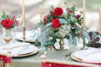 11 a lush greenery and red bloom centerpiece is great for a Christmas wedding