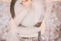 12 a chair covered with tulle, a blush bloom and strands of pearls for a glam vintage wedding