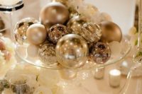 12 a glam winter wedding centerpiece of silver ornaments and white roses for a holiday wedding