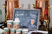 12 a hot chocolate bar is decorated with copper tanks and a chalkboard sign for a cozy winter look
