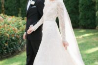12 elegant long sleeve lace wedding dress with a bateau neckline and a small train, a veil finishes off the ensemble