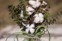 13 a cool arrangement with eucalyptus, cotton and grass in a mason jar for a cozy relaxed wedding