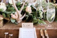 14 a foliage wedding table runner, pastel blooms, antlers and candles for an elegant rustic wedding