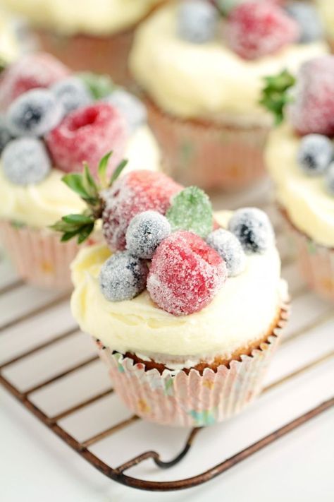 frosted berry cupcakes with an orange mascarpone buttercream feature a fluffy orange cake topped with a luscious frosting, and sugared fruit