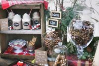 16 a cozy hot chocolate bar with evergrens, faux snow, pinecones and various desserts to choose from