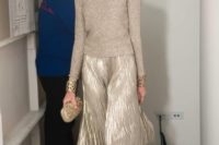 16 a sparkling neutral sweater, a metallic pleated maxi skirt, statement bracelets and an embellished clutch