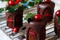 16 mini naked chocolate cakes with berry compote and chocolate dripping, cranberries and leaves on top scream Christmas
