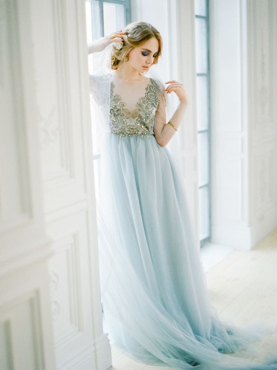 a beautiful wedding dress with an embroidered gold top and an icy blue skirt looks chic and refined