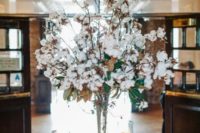 17 a large arrangement with cotton and magnolia leaves will fit winter decor and will make the space cozier