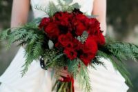 17 a wedding bouquet of red roses and greenery is a great idea for a winter bride