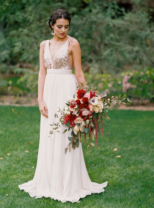 a blush wedding gown with a plunging neckline, no sleeves and a sequin bodice to stand out in pale winter shades