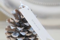 18 a glittered pinecone as a card holder is a chic idea and such a piece can be DIYed