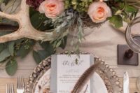 18 a gorgeous bohow edding centerpiece with lush pastel blooms, greenery, feathers and antlers