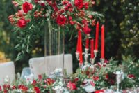 18 a lush Christmas-inspired tablescape in red and green, with red roses, evergreens, printed napkins and lots of faux snow