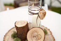 18 a woodland or rustic wedding centerpiece with a wood slice, a wood log, a candles and some moss