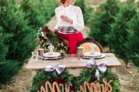 19 an elopement tablescape with lush wreaths with plaid ribbon, red roses and silver goblets