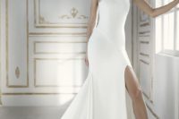 20 a modern wedding dress with a halter neckline, a fornt slit and embellished details
