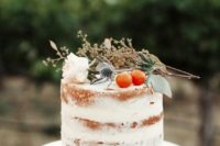 20 a naked wedding cake topped with thistles, citrus and a white rose for a cool aroma