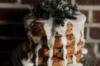 21 a moody winter wedding cake with dripping, cinnamon sticks, privet berries and evergreens
