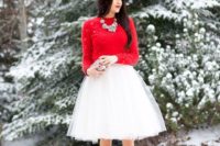 22 a white tutu skirt, a red sweater, red shoes and a statement necklace, a small embellished clutch